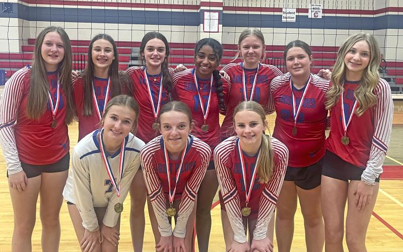 (COURTNEY WRIGHT | CONTRIBUTED PHOTO) The Graham Junior High School 8A volleyball team poses with their first-place medals following a tournament win Saturday, Sept. 28.