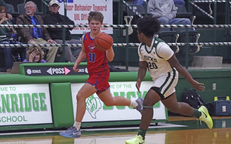 (TC GORDON | THE GRAHAM LEADER) Graham’s Cooper Wilde brings the ball up the court with a Breckenridge defender nearby Monday, Nov. 25 during the Steers’ 49-45 loss to the Buckaroos.