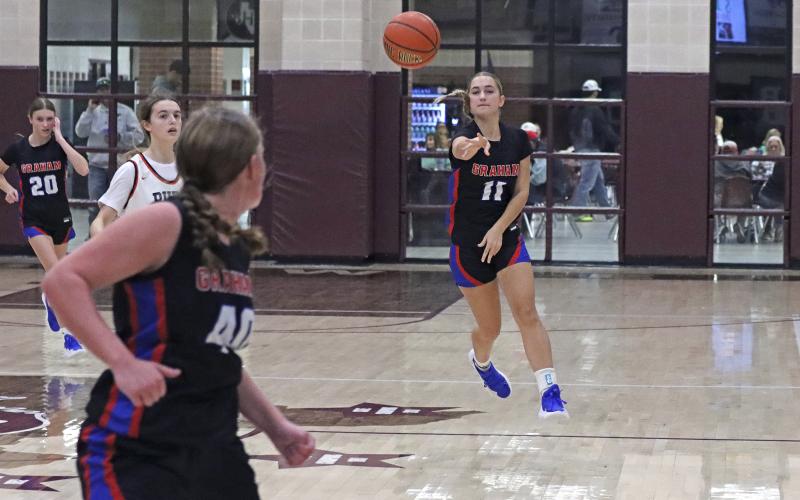 (TC GORDON | THE GRAHAM LEADER) Ava Street (11) passes the ball up the court to teammate Addyson Weaver (40) as the Lady Blues look to score during one of the team’s games at the Bowie tournament which took place Monday, Nov. 25 and Tuesday, Nov. 26.
