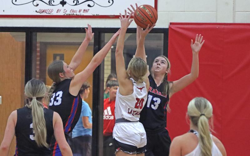 (TC GORDON | THE GRAHAM LEADER) Teammates Briley Randall (33) and Fayth Bryer (13) jump together to try to block a shot from an Eastland player Tuesday, Dec. 3 in Graham’s 60-53 win over the Lady Mavs.