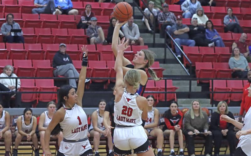 (TC GORDON | THE GRAHAM LEADER) Briley Randall puts up a shot over the arms of a couple of Eastland defenders Tuesday, Dec. 3 during the first half of Graham’s 60-53 win over Eastland.