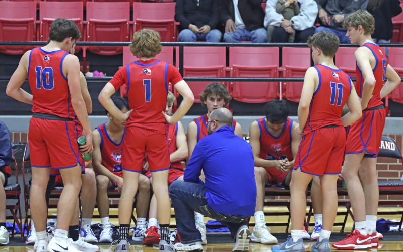 (TC GORDON | THE GRAHAM LEADER) Graham head coach Kyle Wood (middle) talks to his team during a timeout in the second half of the Steers’ dominant 67-51 win against Eastland this past Tuesday, Dec. 3.