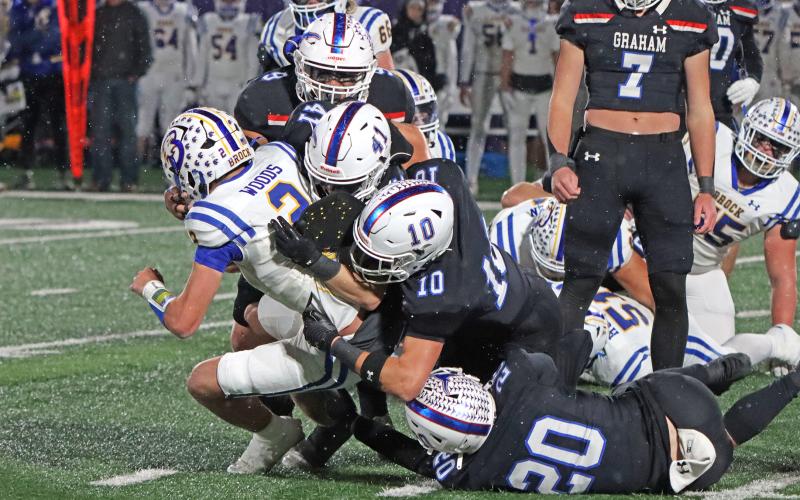 (TC GORDON | THE GRAHAM LEADER) Multiple Graham defenders dog pile the opposing Brock quarterback Friday, Dec. 6 during part of the Steers’ 12-10 triple overtime loss to the Eagles.