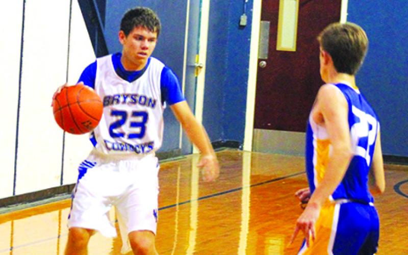 Bryson Cowboys member Jon Alaniz brings the ball down the court in transition during the opening round of the Pirate Classic last Thursday against Bethesda Christian from Perrin-Whitt High School.   Leader photo by Evan Grice