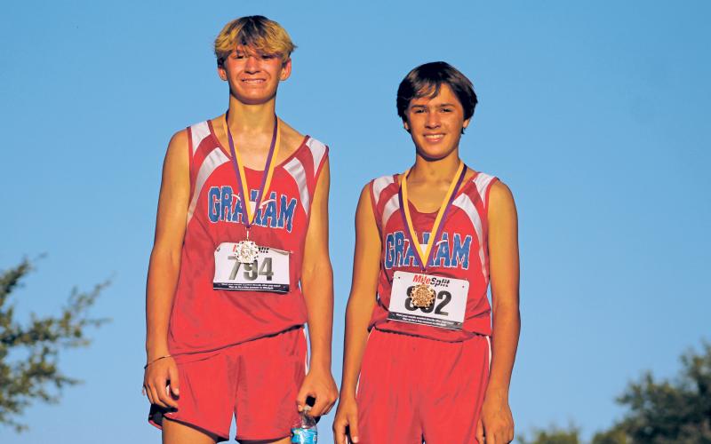 (KYLIE BAILEY | THE GRAHAM LEADER) Andon Masterfield (left) and Cason Walker, both eighth grade runners, medaled Wednesday at the Granbury Race for the Loot cross country meet. Walker, with a time of 13:25.28, and Masterfield, in 13:28.04, finished in 7th and 8th place, respectively. Seventh grade runner Gabriel Rodriguez also medaled at the meet, placing 5th overall. Rodriguez finished in 13:34.88 (not pictured).