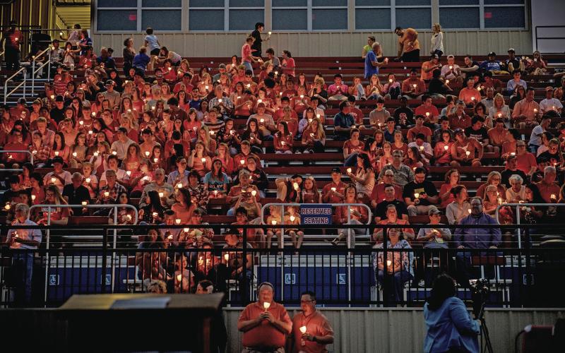 (DAVID FLYNN | CONTRIBUTED PHOTO) Candlelight illuminates those who packed the Graham High School Stadium where GHS students as well as family and friends of Harrison Brown met in his for a vigil May 2, 2017. Brown was killed by Kendrex White in a stabbing spree at the University of Texas at Austin.