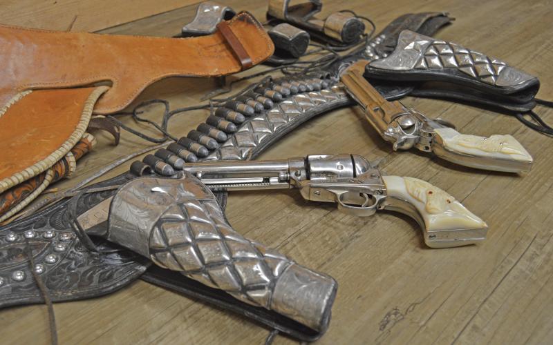 (THOMAS WALLNER | THE GRAHAM LEADER) Pistols and holsters on display at the Young County Museum of History & Culture at 401 Echo St. in Graham. The guns and holsters belonged to Charlie Hipp and the Hipp Rodeo and were donated to the museum for display.