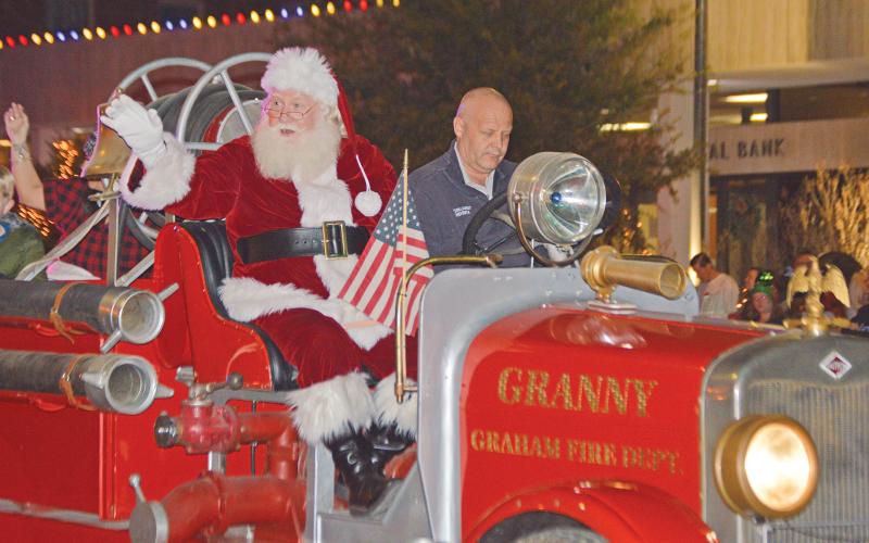 (THOMAS WALLNER | THE GRAHAM LEADER) Graham Fire Department leads the parade with Santa during the 2021 Graham Chamber of Commerce lighted Christmas parade on the Graham downtown square. The parade this year will be held be held at 7 p.m. Thursday, Dec. 1.