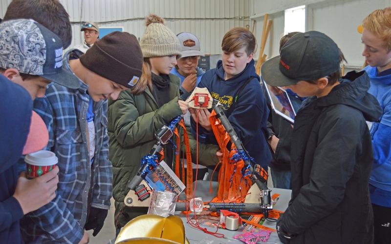 (THOMAS WALLNER | THE GRAHAM LEADER) Open Door Christian School students check components of the base of the payload the STEM class launched on Saturday, Nov. 12 at Graham Municipal Airport. The payload was later found in Keller.