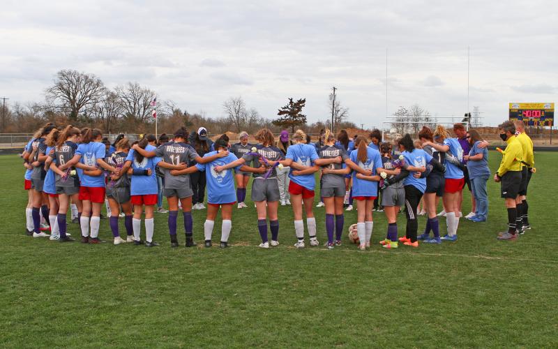 (FILE PHOTO | THE GRAHAM LEADER) The Stephenville Honeybees soccer team gave its support to the Lady Blues in their first match following the death of Harley Grafton. When the teams met March 12, 2022 in Stephenville, the Honeybees decorated the visitor’s side in purple ribbons, the teams said a prayer together before the match and played with 10 players for 11 minutes, which was Grafton’s number on the soccer team. The Lady Blues and Grafton’s family were presented flowers before the match.