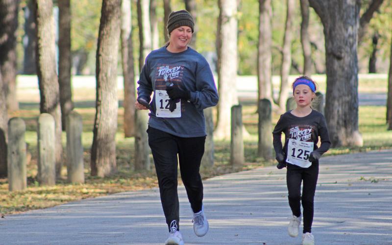 (KYLIE BAILEY | THE GRAHAM LEADER) Two runners close in on the finish line at the Spivey Hill Challenge held at Fireman’s Park Saturday, Nov. 12.