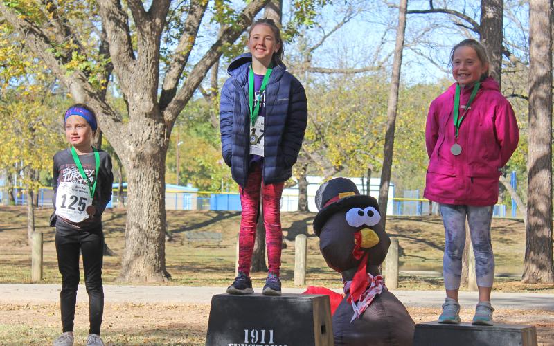 (KYLIE BAILEY | THE GRAHAM LEADER) Female 10 and under winners in the Spivey Hill Challenge 5K race. The top three winners were Zihna Wuthrich, Kenzie Kramer and Emerson Brewer.