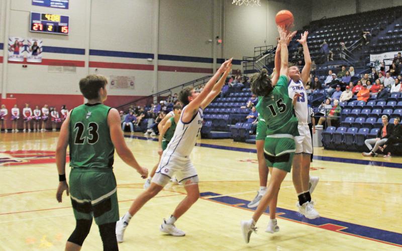 (MIKE WILLIAMS | THE GRAHAM LEADER) Kolby Spurlin (13) battles for a rebound during the second quarter of the Steers’ 63-55 win over Iowa Park Tuesday, Dec. 13 at Graham High School. The physical game finished with a combined 48 fouls called between the two teams.
