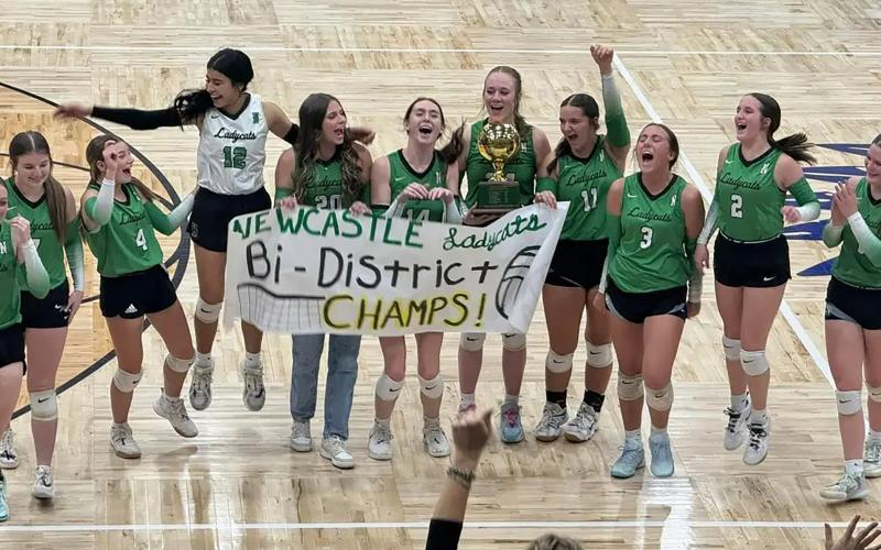 (NEWCASTLE BOOSTER CLUB | CONTRIBUTED PHOTO) The Ladycats celebrate their bi-district win Thursday, Oct. 30, over the Lady Greyhounds. The Ladycats had a gritty performance as they advanced to the area round of the playoffs. 