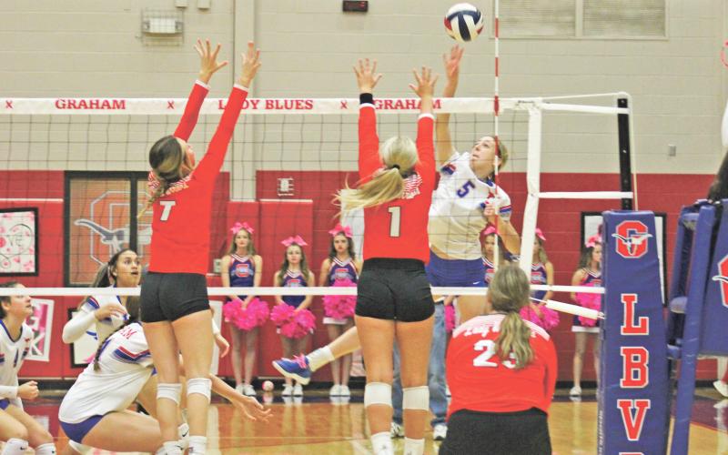 (MIKE WILLIAMS | THE GRAHAM LEADER) Lady Blues sophomore Braylee Mayes goes for a kill during the first set of the Lady Blues’ 20-25, 25-17, 25-17, 25-21 home win over Wichita Falls Christ Academy Friday, Oct. 21 at Graham High School. The match was the final scheduled home match of the season for the Lady Blues.