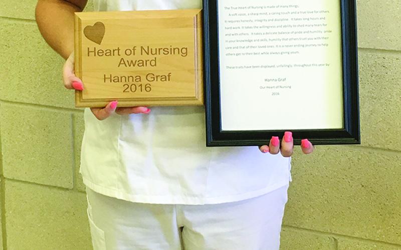 Hannah Graf, LVN graduate, is all smiles as she displays the NCTC Heart of Nursing Award she received during the Aug. 9 pinning ceremony.