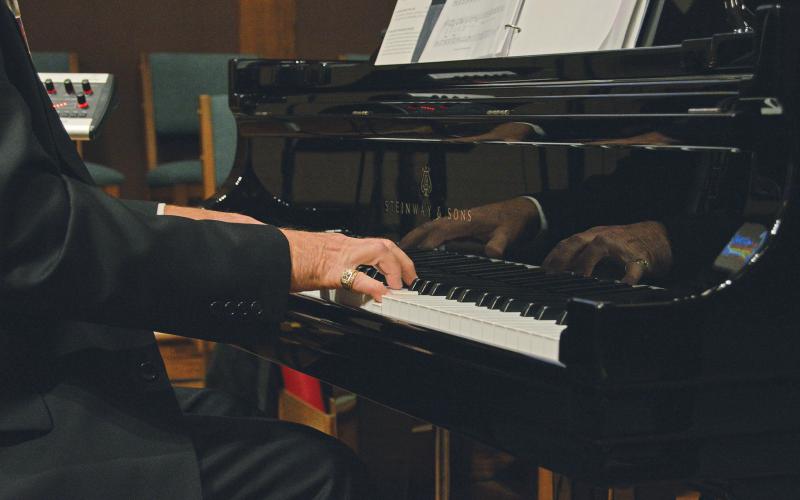 (THOMAS WALLNER | THE GRAHAM LEADER) Jerrol Higgins warms up Sunday, Dec. 18 before his last piano performance at First United Methodist Church in Graham. Higgins has played piano for the church for 13 years and gave a closing speech to the congregation Sunday.