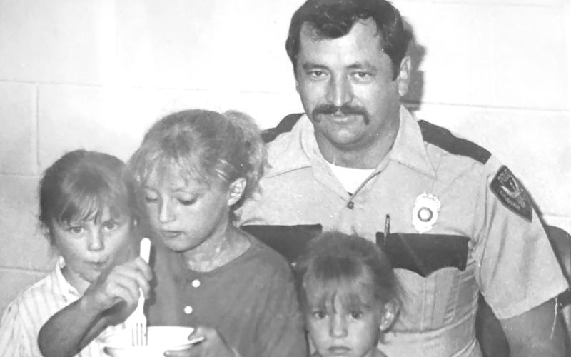 (CONTRIBUTED PHOTO | STEPHEN BRISTOW) Stephen Bristow with his three daughters at a Graham Police Department going away party in August 1986.Shown in front from left to right are his daughters Patricia, Jennifer and Stacy. Shown in back is Bristow in uniform.