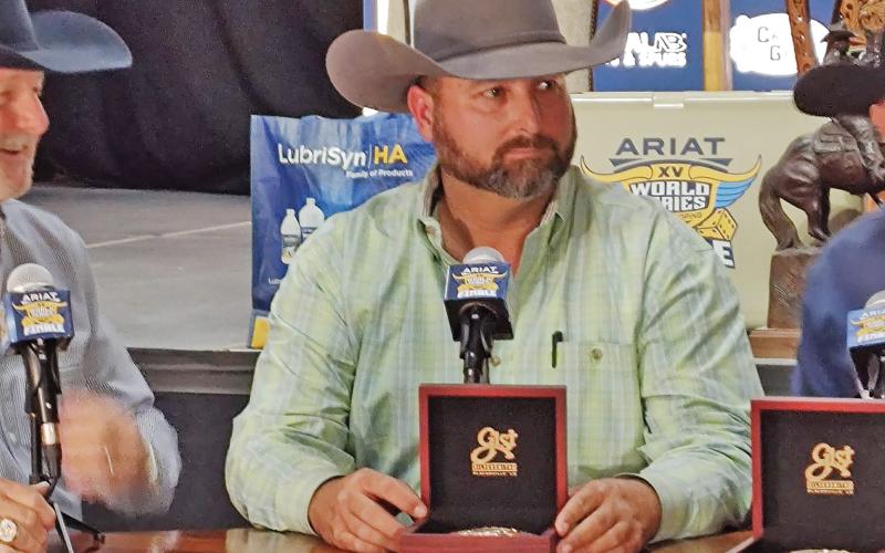 CONTRIBUTED PHOTO | STEPHANIE CAMPBELL) Tyrel Campbell, of Graham, shows off a buckle from the 2021 World Series of Team Roping. In 2021, Campbell and Mac Fairey won the #8.5 title during the World Series of Team Roping finale.