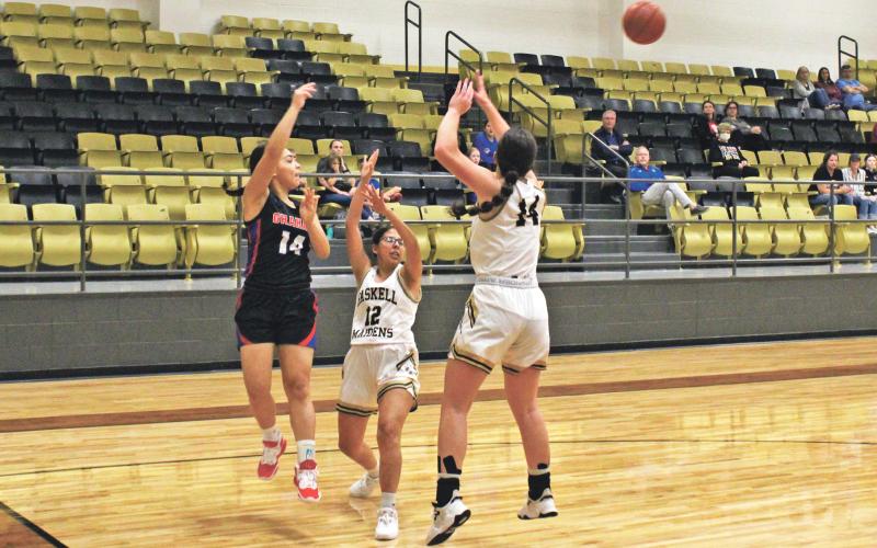 (MIKE WILLIAMS | THE GRAHAM LEADER) Lady Blues senior Sadie Salazar passes out of a double team during the first quarter of the Lady Blues’ 55-29 loss to the Maidens on Tuesday, Nov. 8 at Haskell. The Lady Blues struggled with consistent full-court pressure from the Maidens.