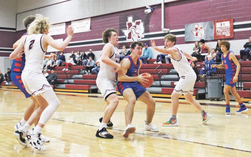 (MIKE WILLIAMS | THE GRAHAM LEADER) Ty Thompson battles a double team Friday, Dec. 30 near the basket during the third quarter of the Steers’ 58-53 win at Millsap High School. Thompson finished the game with 15 points. The Steers met Kerens in a neutral site game at Burleson Tuesday, Jan. 3 and will host Old High Friday, Jan. 6.