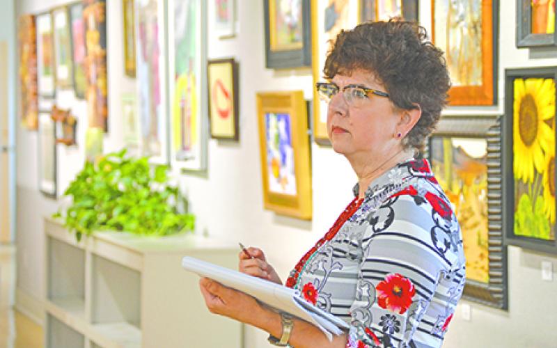 Former Graham ISD Art Director Kathy Lambden judges art entires in the 2016 Lake Country Art Show and Sale. The show brings together 134 pieces of artwork from over 30 artists spread across Breckenridge, Weatherford, Mineral Wells, San Angelo, Granbury and other local West Texas towns. 