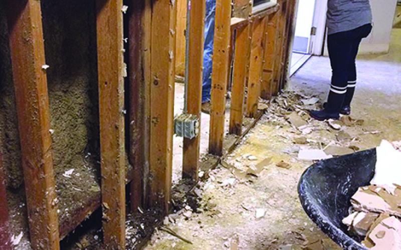 Melissa Croxton, part of a group from Oak Street Baptist Church in Graham, is shown removing sheetrock at Of the Way Bible Church in Baton Rouge. Courtesy photos