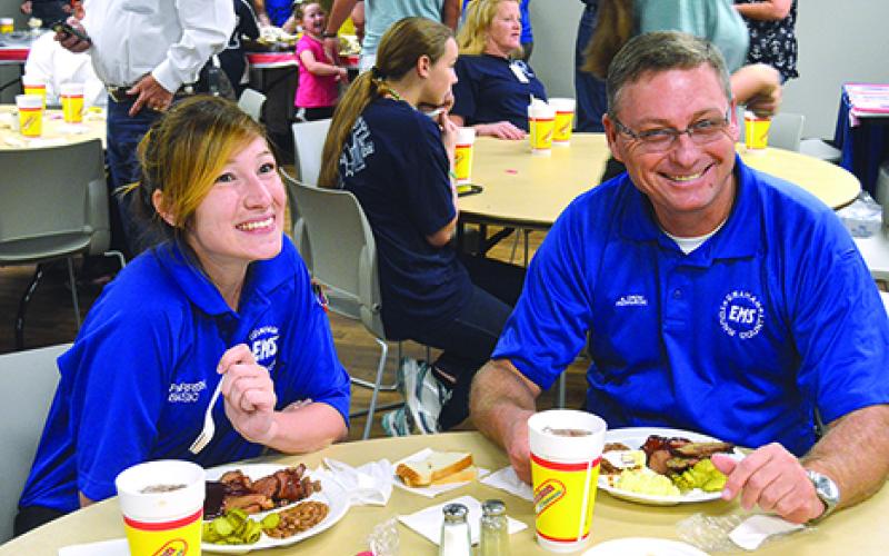Shawnee Parrish and Kiowa Crow of Graham EMS take a break to eat some barbecue from the Young County Serving Our Servants meal, which welcomed first responders county-wide. 