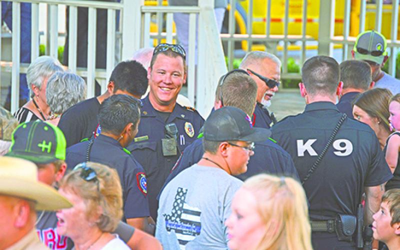 Graham Police officers, above, including Kyle Ford, facing camera, visit with the public after the prayer service is over and shake hands with those in the audience who thanked them for their service to the city and county, during the “Back the Blue Support our Responders” event and prayer vigil, held Aug. 2.