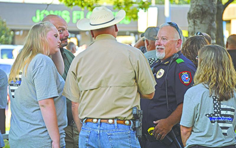 Incoming Young County Sheriff Travis Babcock talks to current Sheriff Bryan Walls after the Back the Blue Support our Responders event and prayer vigil on the Young County Courthouse lawn.  