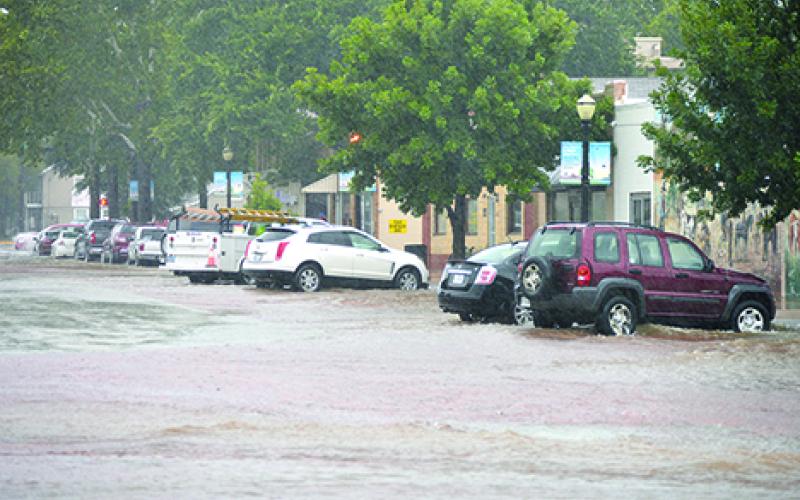 Parked cars on Second Street in Graham had water approaching their undercarriages during Friday’s deluge. (Leader photo by Thomas Wallner)