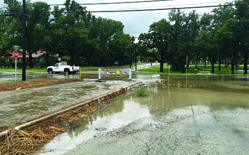South and Cherry streets were blocked off Friday due to water over the roadways that caused some vehicles to stall. (Leader photo by Kylie Bailey)