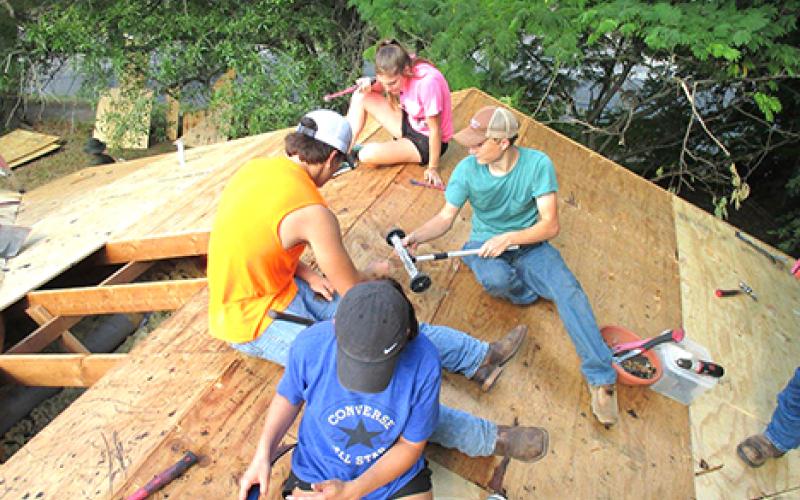 Shown helping repair flood-damaged homes in Taylor are, clockwise from top,  Kelsey Shields, Jeb Owens, Mackenzie Lowe and Matthew Lowe, of First United Methodist Church of Newcastle.