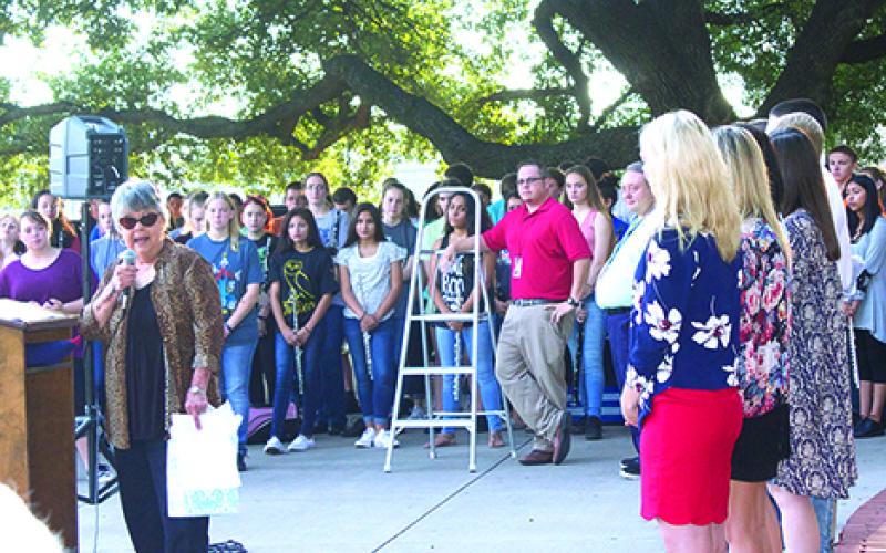 Betty Burgess, regent of the Silas Morton Chapter of the Daughters of the American Revolution, gives recognition to Graham High School Student Council vice president Jessica Burgess (front, right) for her speech at the 79th annual Graham DAR Flag Raising Ceremony. Jessica is Betty Burgess’ granddaughter. 