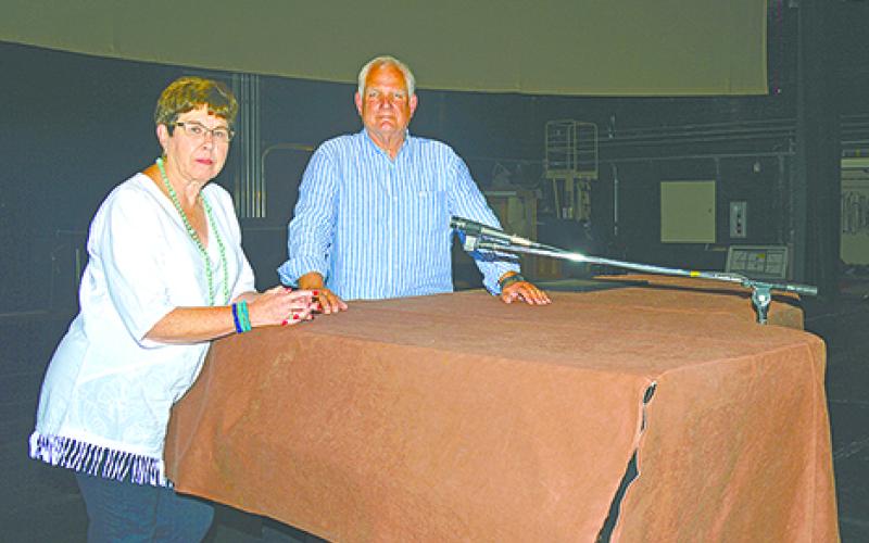 Graham Concert Association member Ellen Morris and President Carter Pettit sit on the stage of the memorial auditorium that was built in 1929 and will host six performances from the association this season. The association is constantly looking for new members to join and help continue the arts in Graham.  (Leader photo by Thomas Wallner)