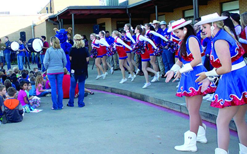 The GHS Bella Blues and cheerleaders perform for the Crestview student body during the Crestview Homecoming pep rally Thursday morning.