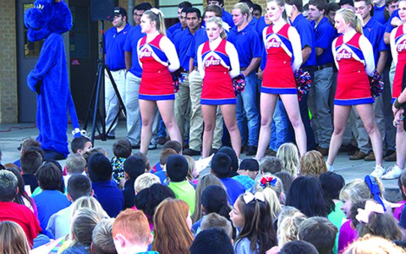 The Graham High School cheerleaders and football team make an appearance at the Crestview Elementary Homecoming pep rally Thursday morning.
