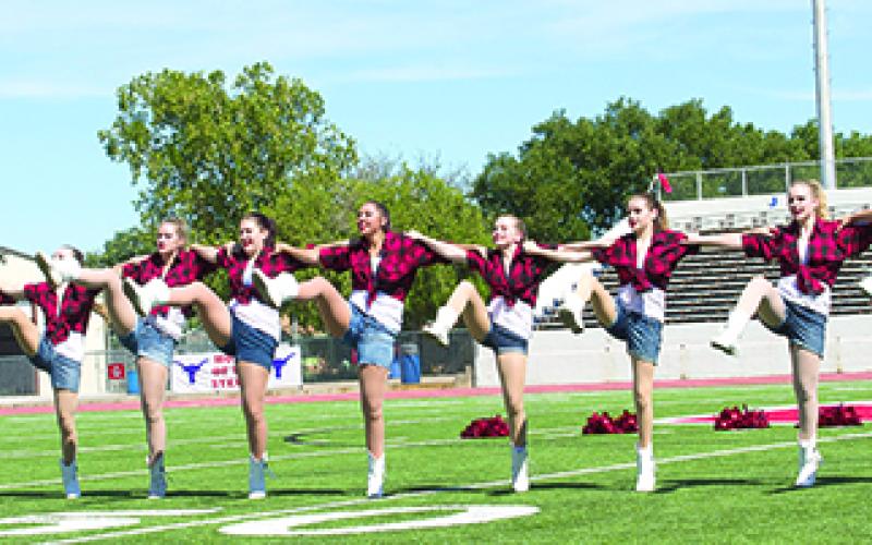 The Bella Blues perform a kick-line at the GHS Homecoming pep rally on Thursday afternoon.