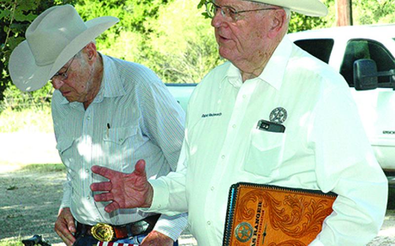 Retired Texas Ranger Ralph Wadsworth, right, speaks to the crowd gathered Oct. 6 to place a Texas Ranger Memorial Cross at the Farmer’s Cemetery gravesite of Charles Lemuel Ray. Ray and his brother, Joseph, served in the Rangers’ Frontier Battalion from 1874-75.