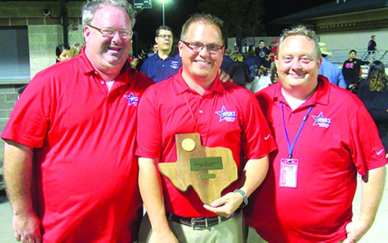 Graham ISD Band Directors (l-r) Hugh Grubbs, Josh Kidd and Dax Freeman pose with the eighth-place trophy that the Rompin' Stompin' Big Blue Band of Graham High School earned following two outstanding performances at the UIL Area B Marching Competition in Denton Saturday. Courtesy photo