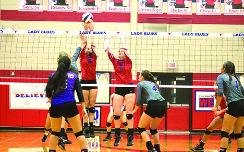 From left, Skylar Morris and Chloe Menard went up for a block in the Blues 25-17; 25-17; 25-21 win over Jacksboro Tuesday night in Graham. The Blues are now ranked No. 15 in the state in 4A by the Texas Girls Coaches Association. (Leader photo by Travis Lisle)