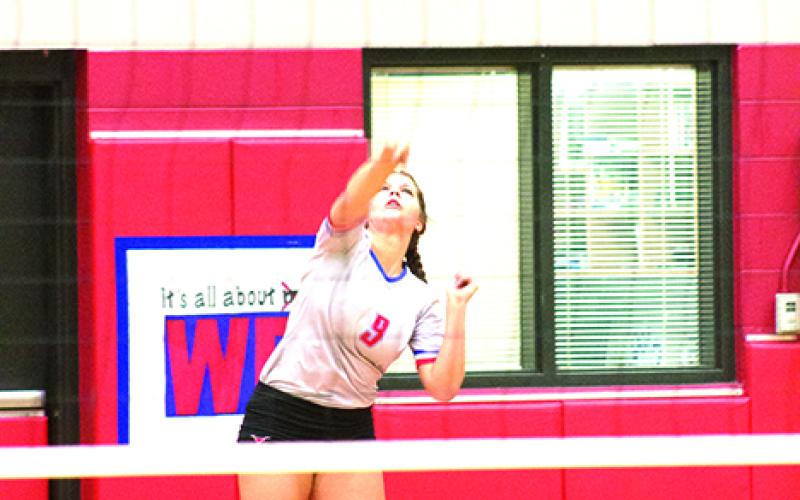 Emily Davis serves one up during the Blues’ win over Wichita Falls Old High on Tuesday. Davis has performed as one of the Blues top all-around players.