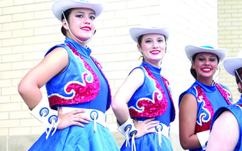 The Bella Blues posed for promotional photos Tuesday morning in front of the Graham High School gymnasium. The drill team sighting is yet another reminder that the excitement and pageantry of Friday night football is close at hand.
