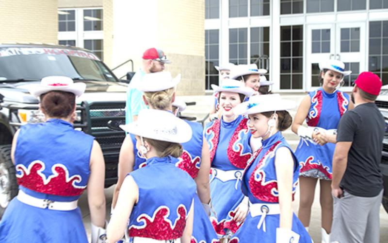 The Bella Blues posed for promotional photos Tuesday morning in front of the Graham High School gymnasium. The drill team sighting is yet another reminder that the excitement and pageantry of Friday night football is close at hand.