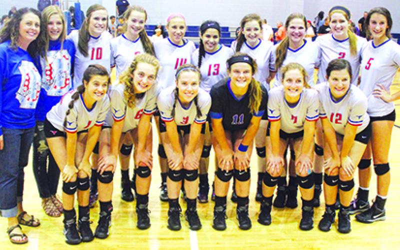 Members of the Graham Lady Blues varsity volleyball team along with head coach Marci Faulk pose for a team photo Friday afternoon at Windthorst High School following the Lady Blues’ sweep of the Burkburnett Lady Bulldogs by scores of 25-16, 25-23, 26-24, which earned them the No.1 seed for the upcoming playoffs. Leader photo by Evan Grice