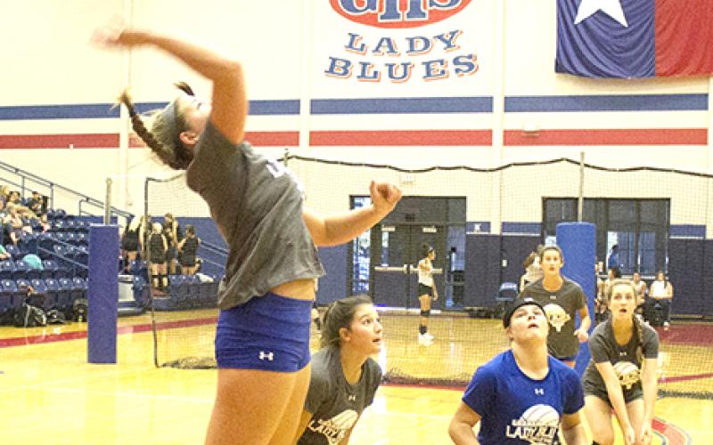 Emily Davis goes up for the kill while Delaney Sullivent, Marleigh Sanders, Nicole King, Jasmine Sims and Baylee Loomis get into defensive position at the Lady Blues’ home scrimmage against Bowie Friday morning.