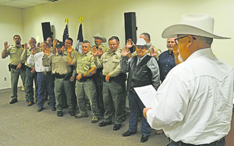 Newly-elected Sheriff Travis Babcock, gives the oath of office to every deputy at the sheriff’s department on Sunday, Jan. 1 at the Young County Sheriff’s Department. 