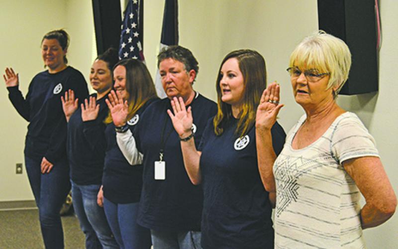 Young County Sheriff’s Office dispatch staff receive the oath of office from newly elected sheriff Travis Babcock at the Young County Sheriff’s Department on Sunday.