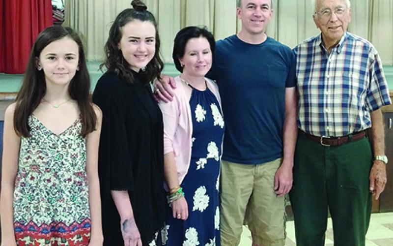 Honored for traveling the greatest distance to the 64th annual Rocky Mound Reunion were Michael and Debby Anderson, with their daughters Katie and Claire, who attended from Prosper. With them, far right, is Monroe Robertson, who was honored for being Most Senior Gentleman in attendance.