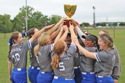 (ARCHIVE PHOTO | THE GRAHAM LEADER) The Lady Blues hoist the district championship trophy in the air after defeating Mineral Wells 13-7 to win first place in the district standings. The team finished with a 6-2 district record to earn the title.